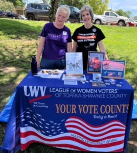 two members at a voter information table